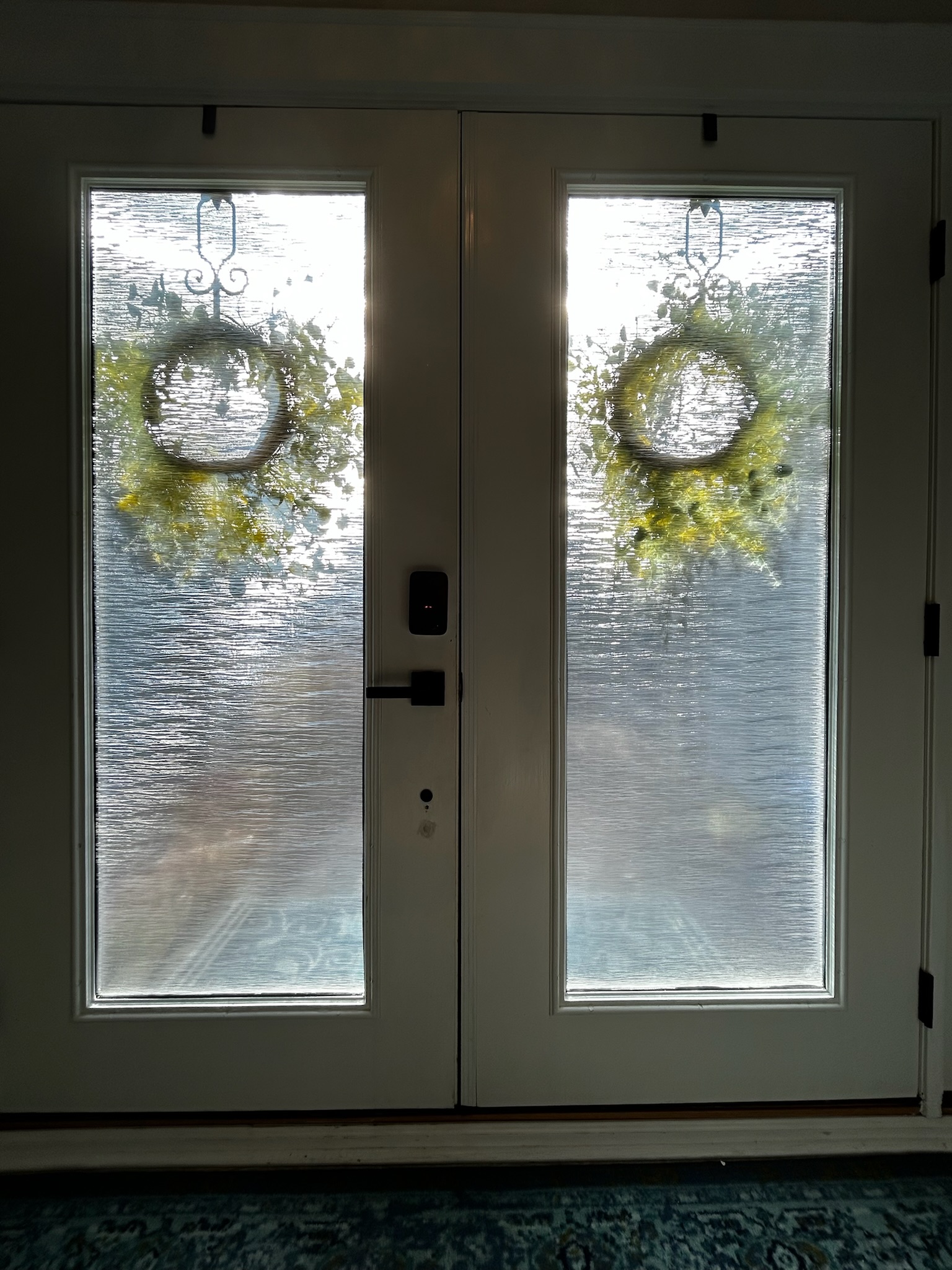 Front door windows with wtreaths and a stained glass look